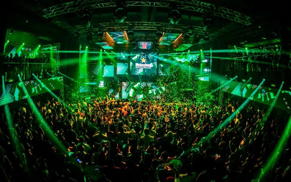 Heineken Live Your Music event with green lighting and a full crowd