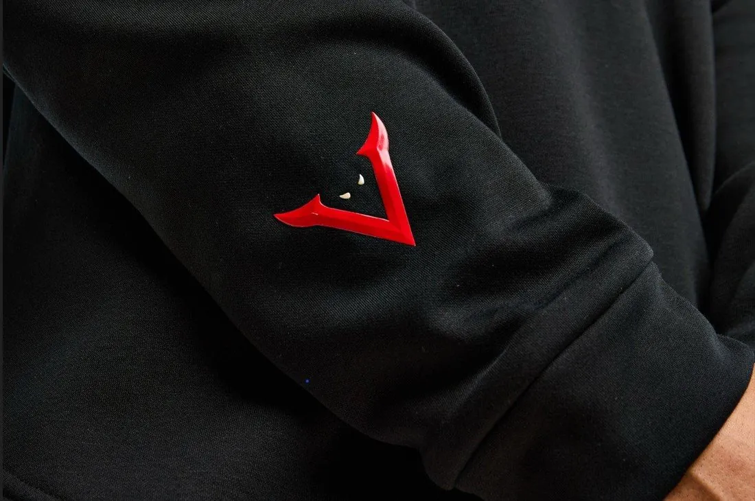 Close detail of the red embossed V emblem on the sleeve of a black Verrati garment